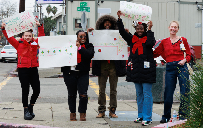 AHS Health Advocates Team with signage to Hope for the Holidays event